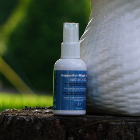 Spray bottle with blue label on a wooden surface with a blurred background.