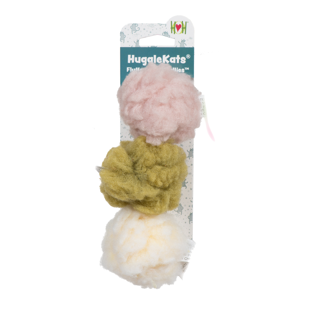 Three pom-poms in pink, yellow, and white on a HuggleMutt branded card against a white background.