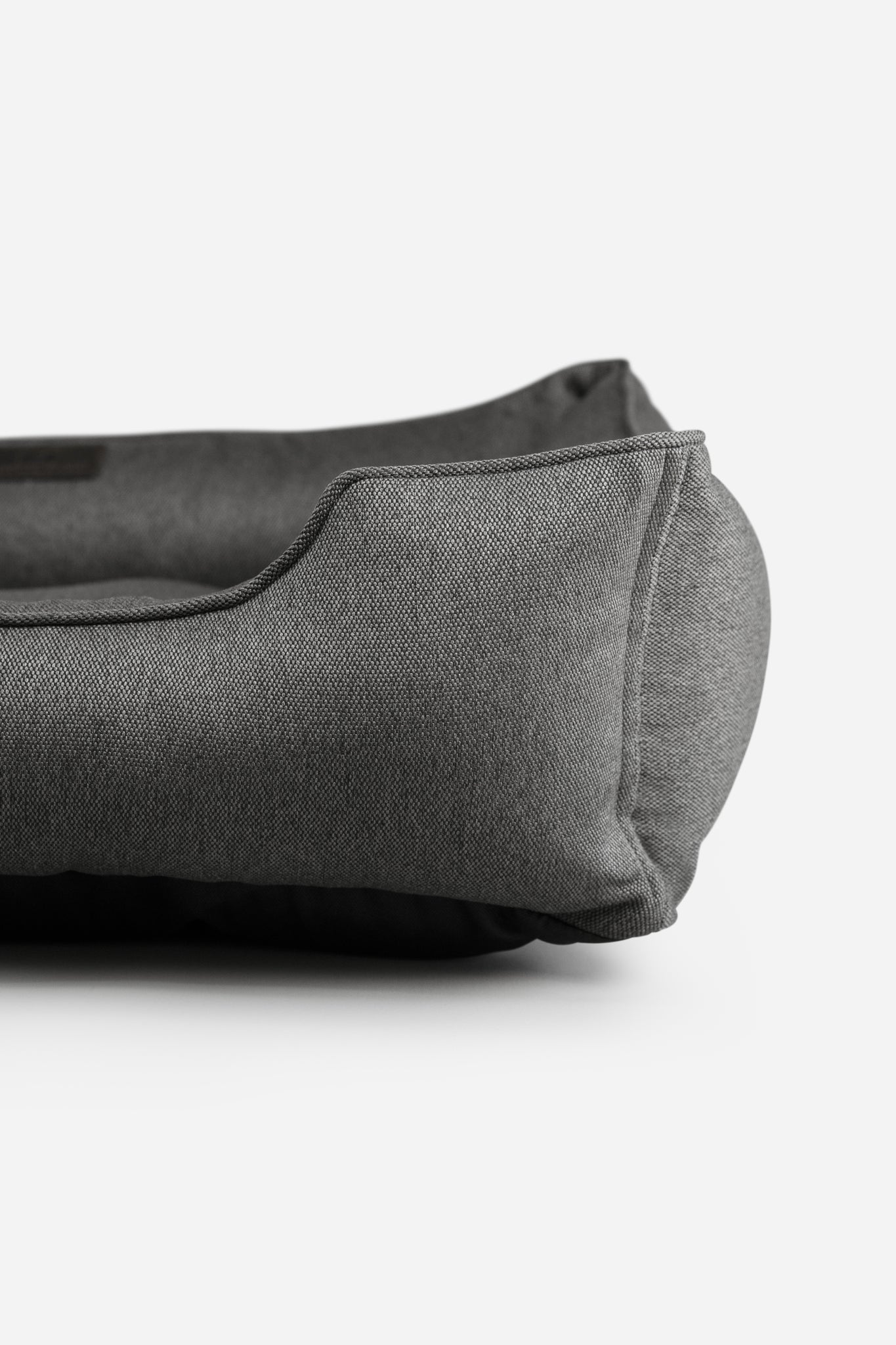 Gray tweed plush pet bed on a white background.