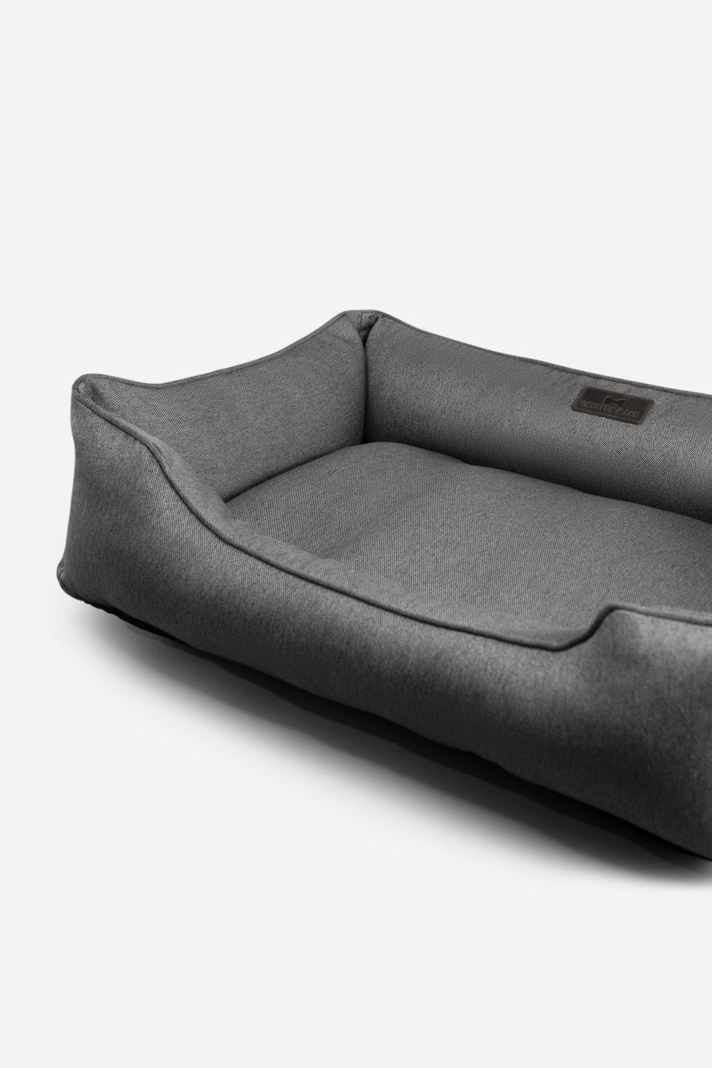 Gray rectangular tweed plush pet bed on a white background.