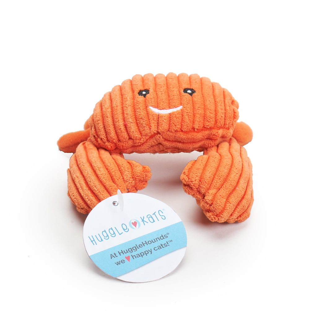 Orange plush crab cat toy with a tag displaying 'HuggleMugs' on a white background.