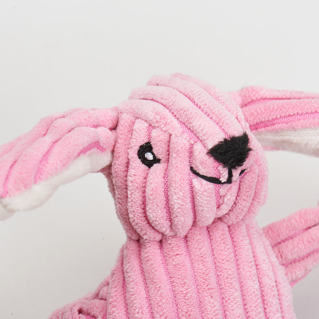 Pink plush bunny cat toy with a white background.