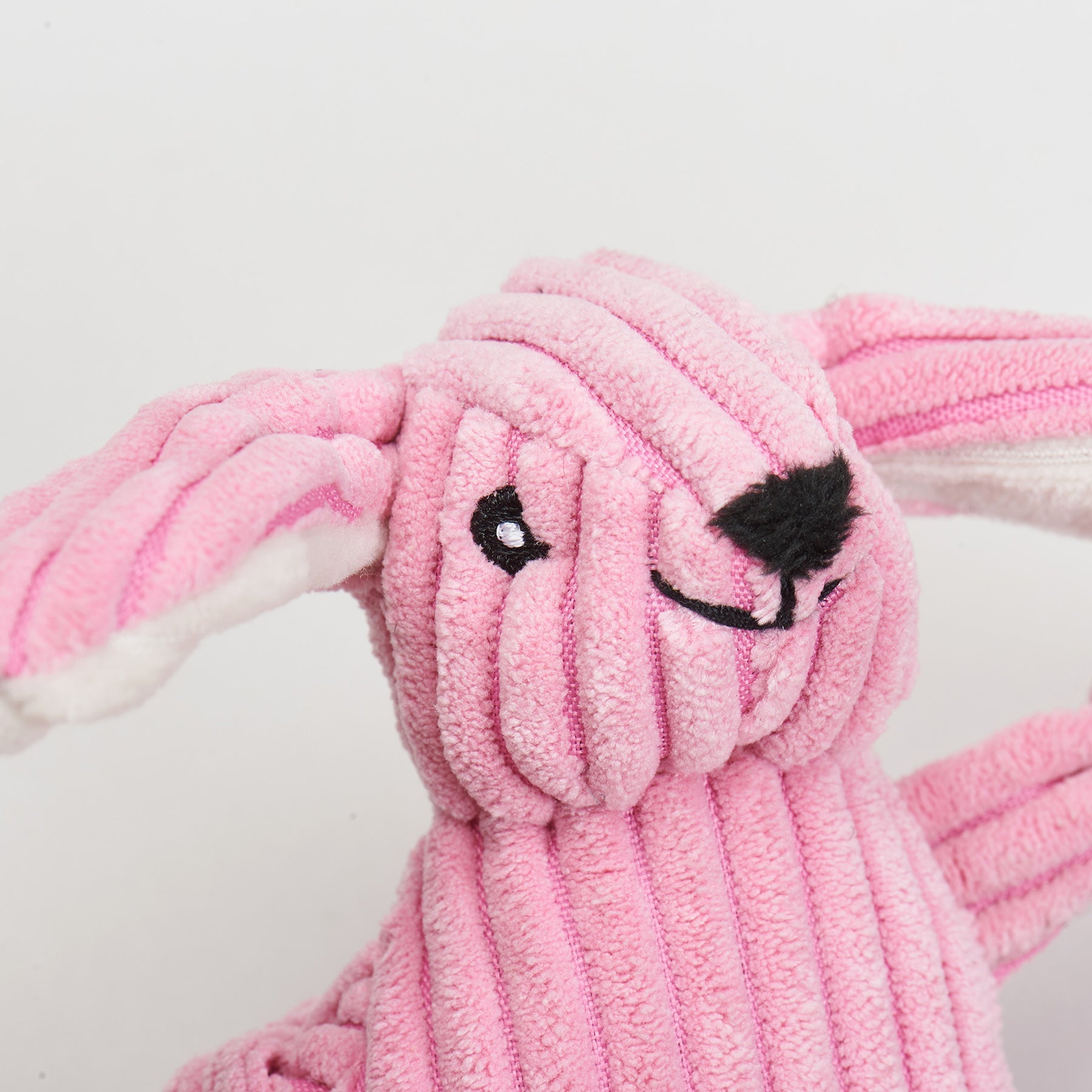 Pink plush bunny cat toy with a white background.