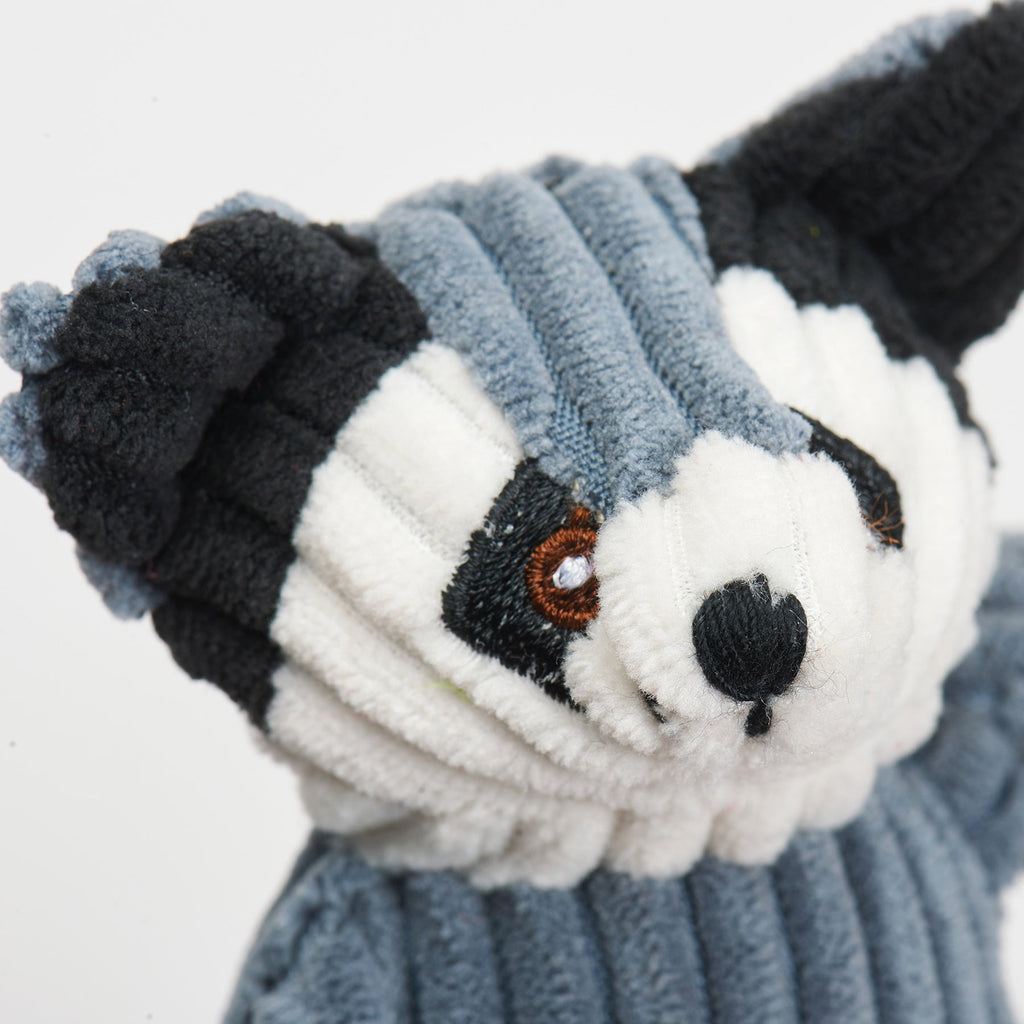 Plush cat raccoon toy with a face design on a white background.